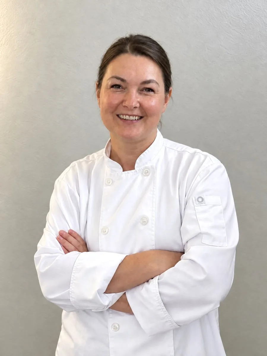 Chef Tatiana in a white chef coat
