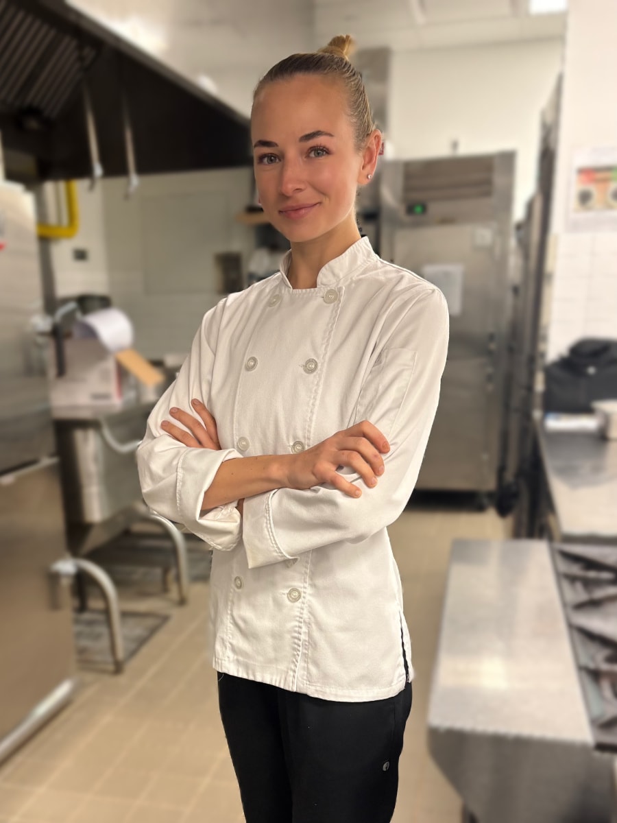 Chef Ana Artemyeva wearing chef whites in a professional kitchen