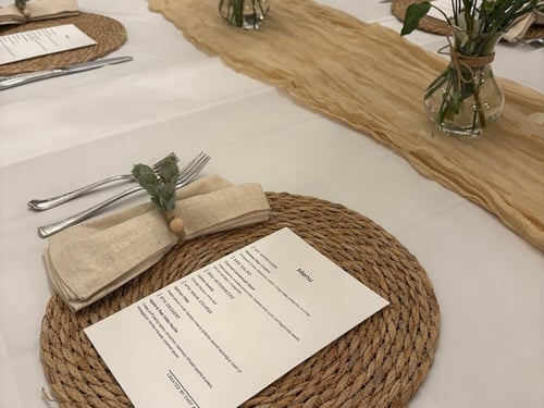 Dining table set with printed menus before a private dinner