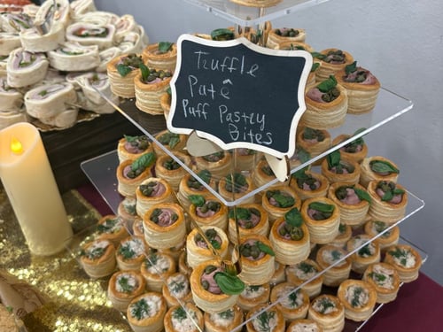 Tiered display of truffle pate and tuna puff pastry bites.