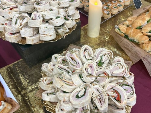 Platters of turkey pinwheel wraps and cheese pinwheel wraps.