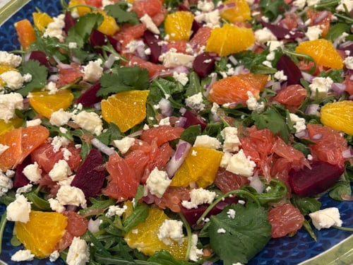 Vibrant beets and citrus salad with feta and red onion.