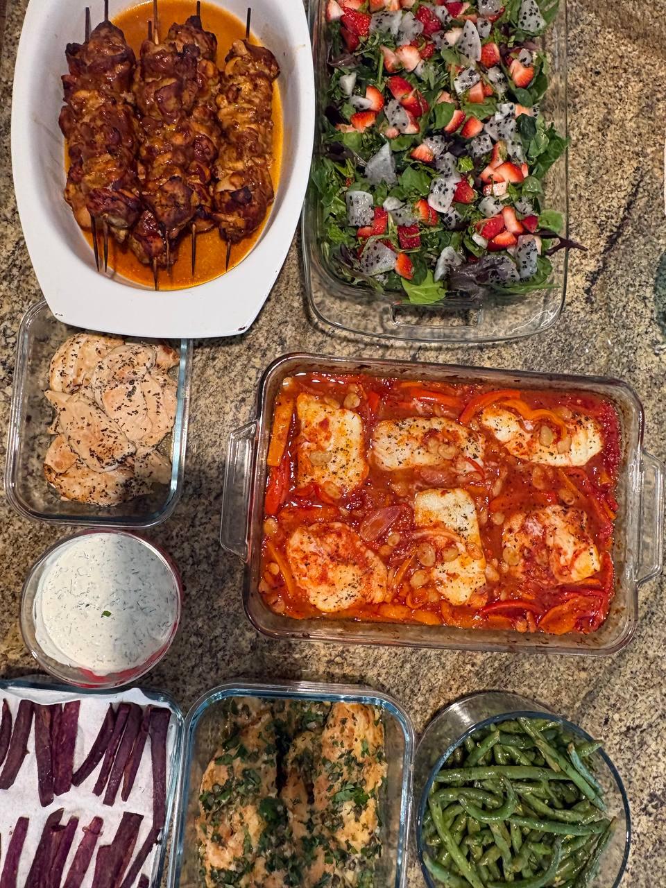 table is filled with various dishes, including a casserole