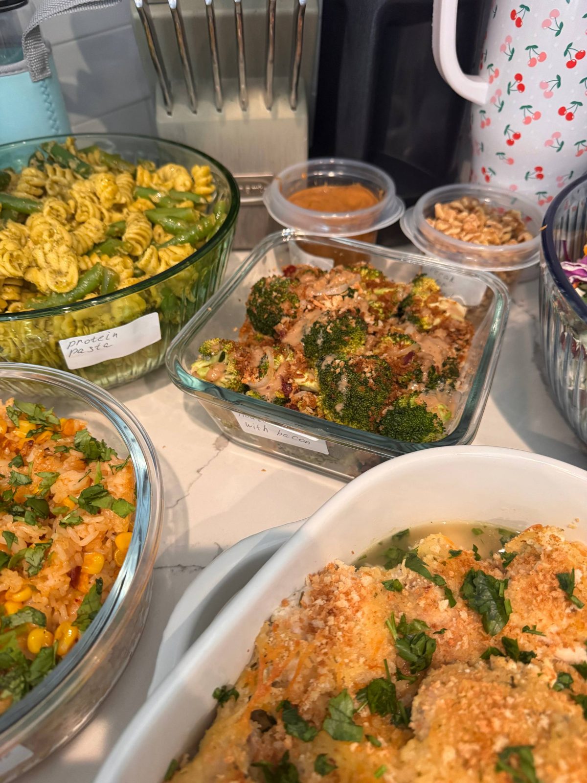 table filled with various dishes, including a bowl of pasta