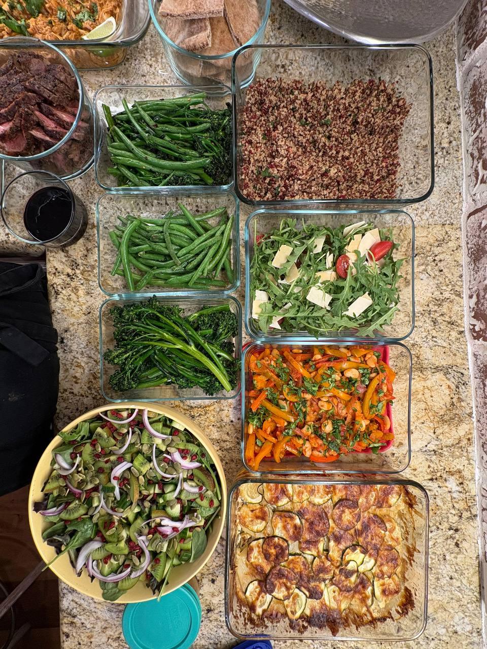 table with a variety of food items, including vegetables