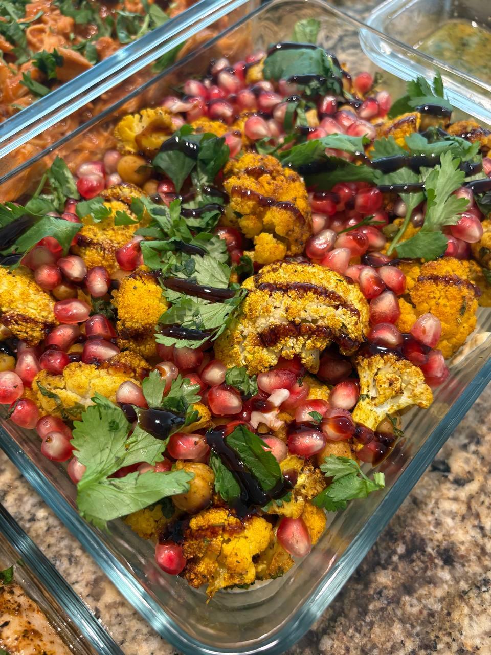 dish filled with a variety of vegetables, including pomegranate seeds