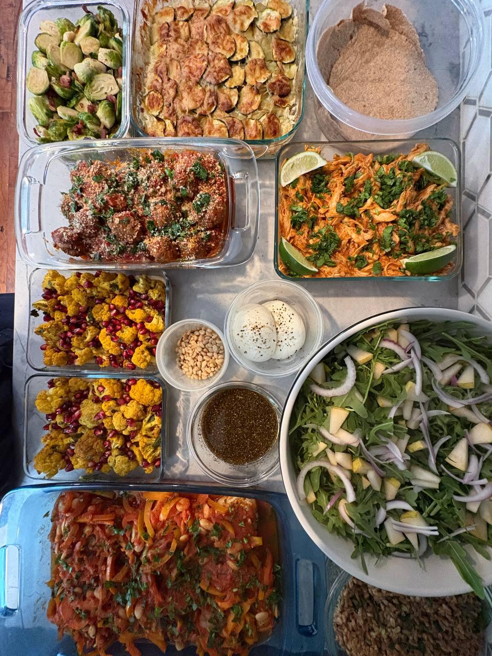 table is filled with various dishes, including a salad