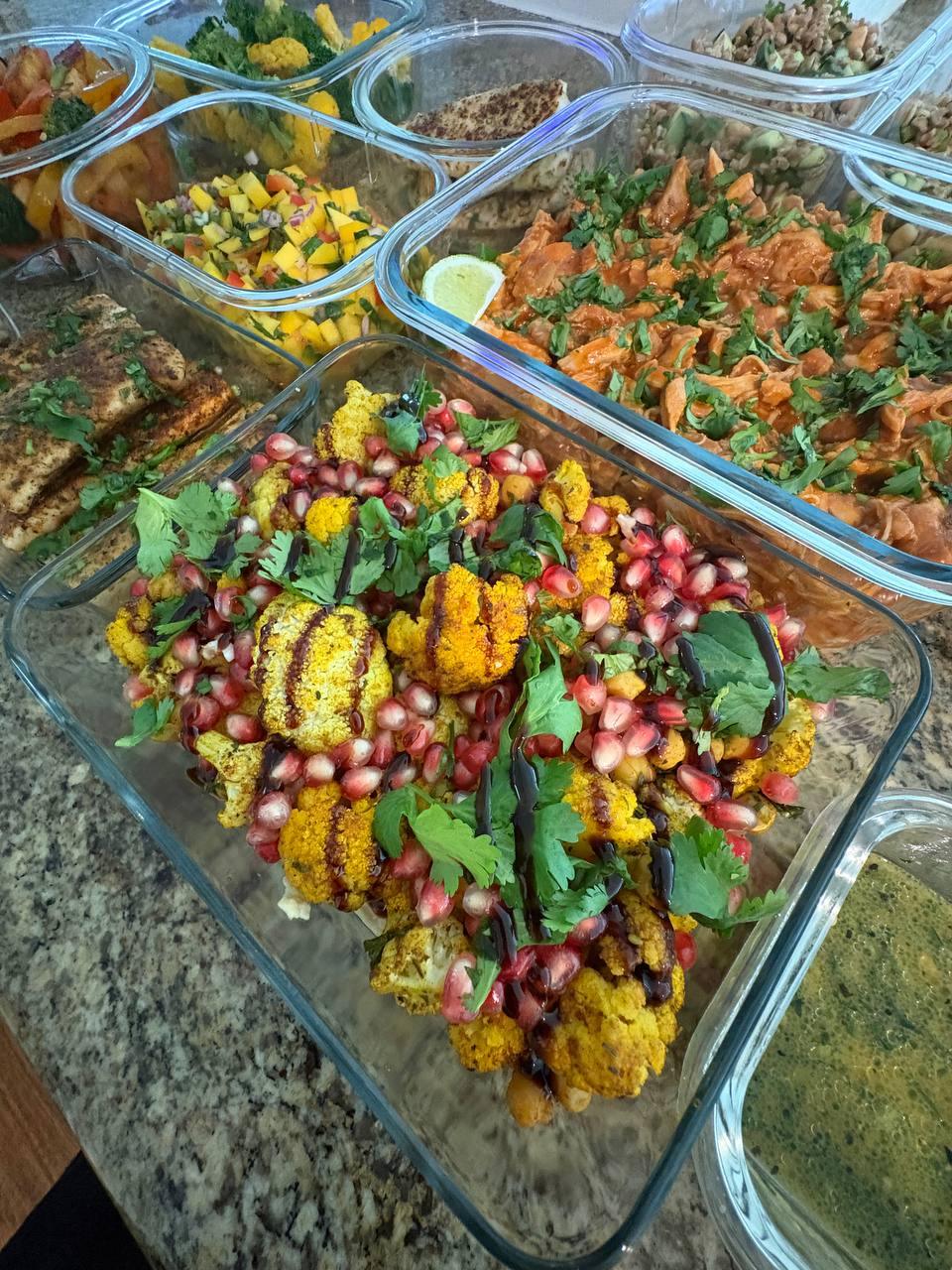 variety of foods are displayed on a dining table including a salad