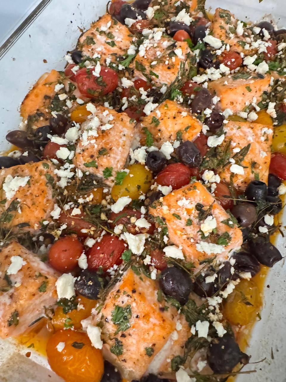 dish of grilled fish with tomatoes, olives