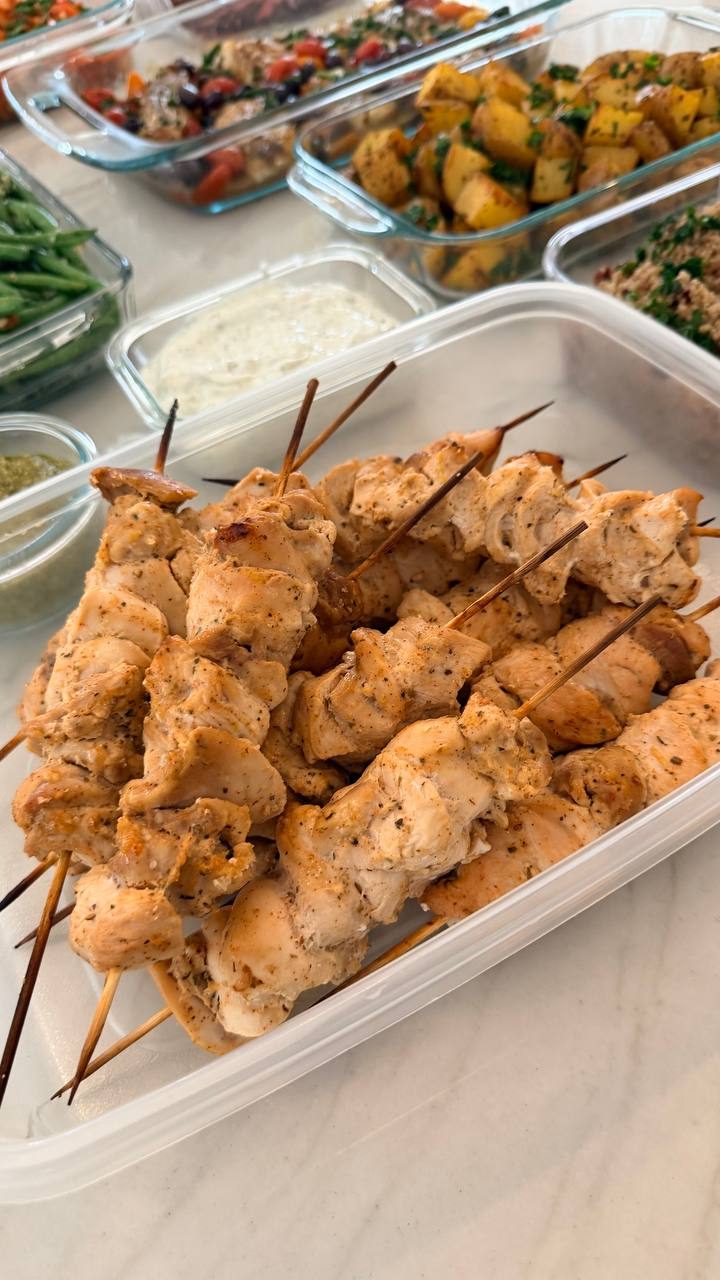 plastic container filled with marinated chicken skewers
