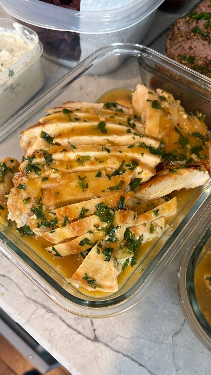 glass container filled with chicken and herb