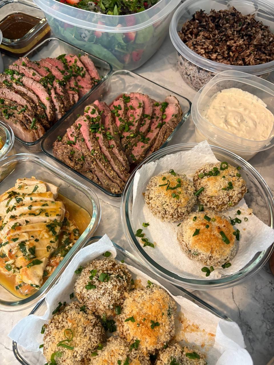 table with various dishes, including meat, vegetables