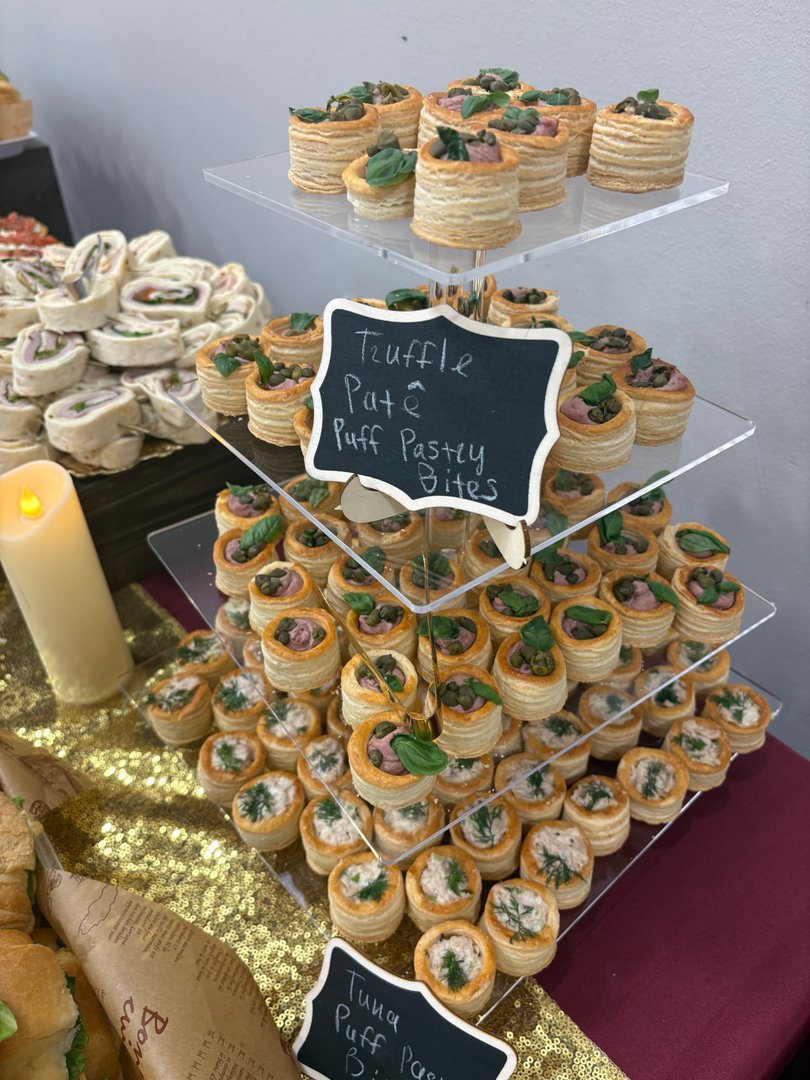 Tiered display of truffle pate and tuna puff pastry bites.