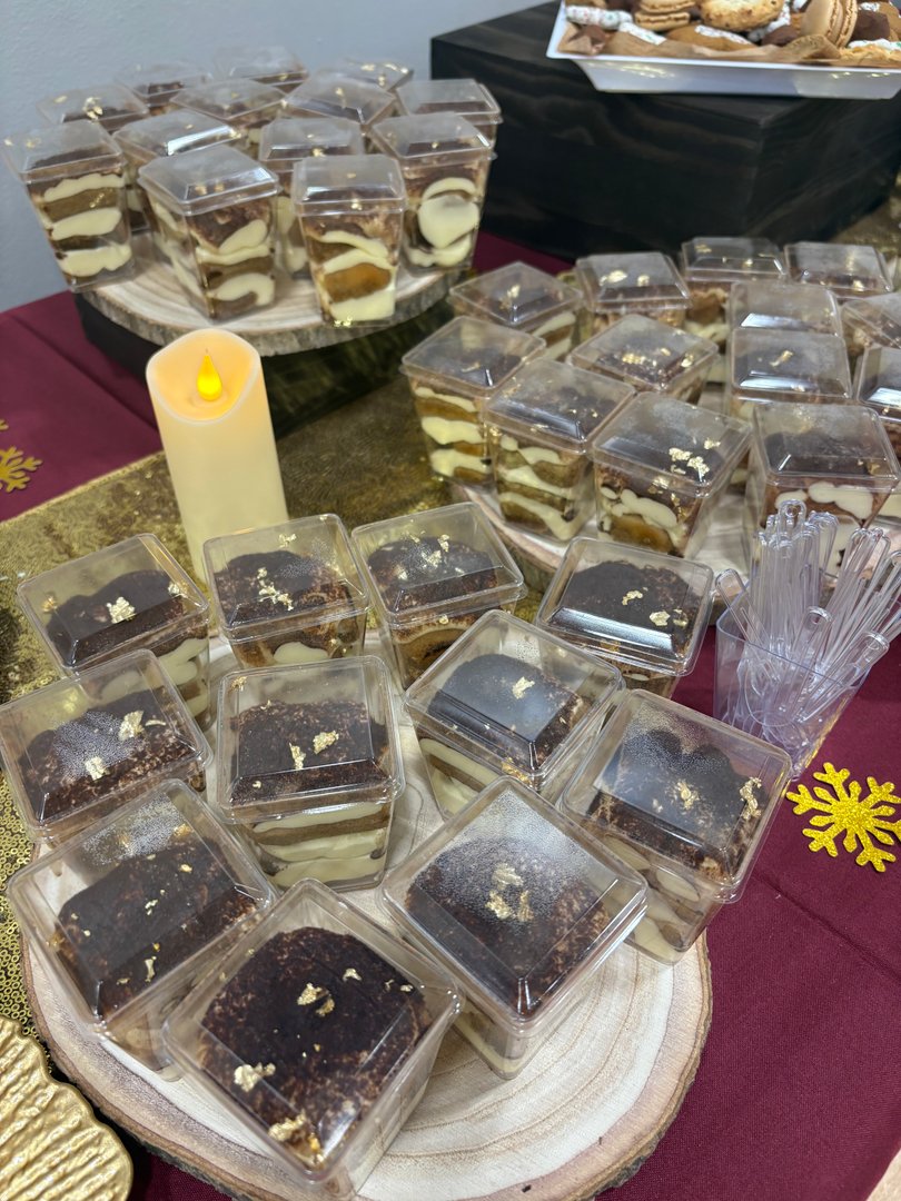 Individual tiramisu cups and gold-dusted chocolate desserts.