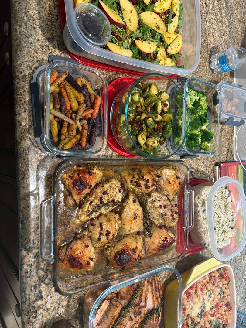 Overhead view of winter harvest meal prep, including roasted chicken and sides.