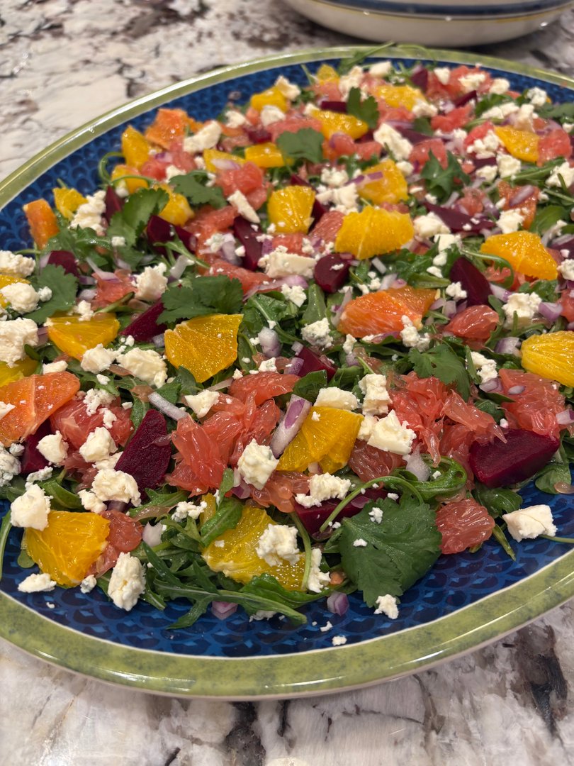 Vibrant beets and citrus salad with feta and red onion.