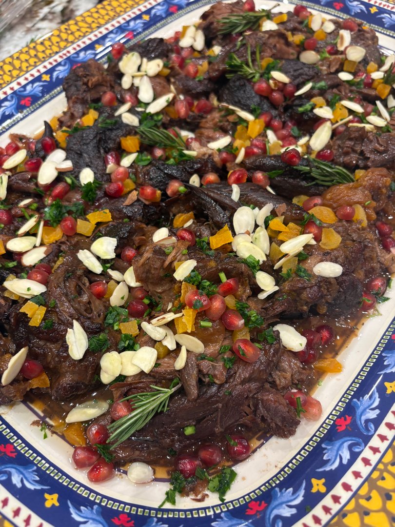 Slow-cooked lamb shoulder with apricots, pomegranate, and almonds.