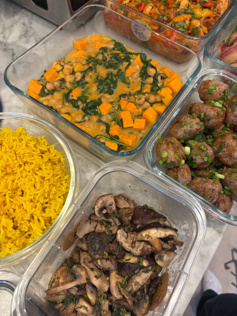 Assortment of meal prep dishes including rice, mushrooms, and chickpea curry.