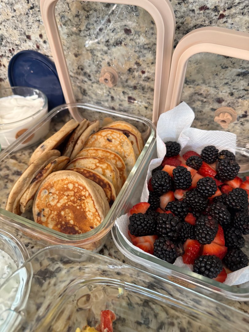 Fluffy blueberry pancakes with fresh strawberries and blackberries.