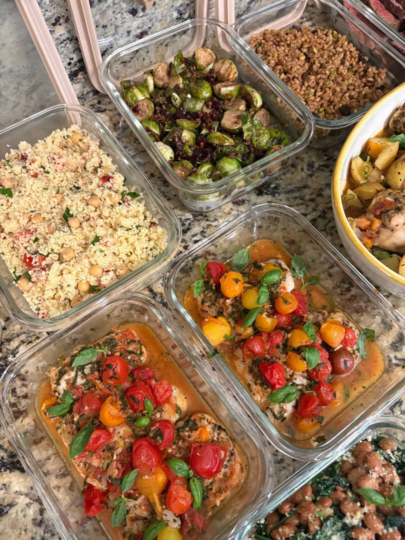 Overhead shot of various meal prep containers with global fusion dishes.