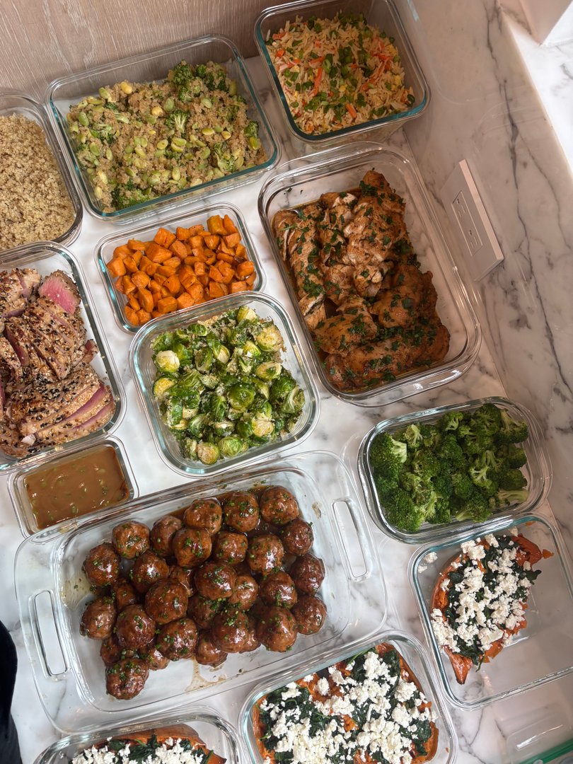 Assortment of meal prep containers with various cooked dishes.