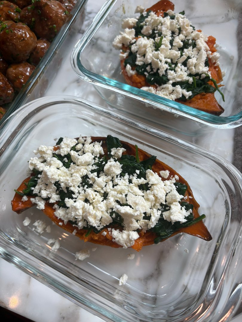 Sweet potato halves topped with spinach and crumbled feta.