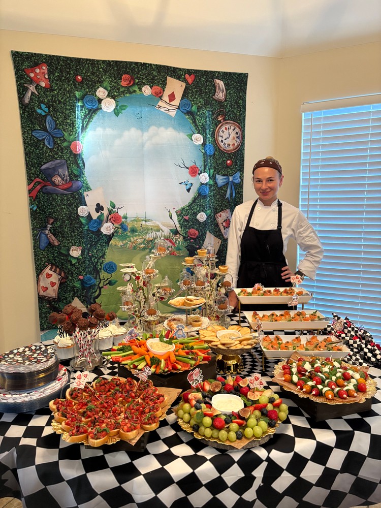 Chef Ana presenting a festive buffet spread