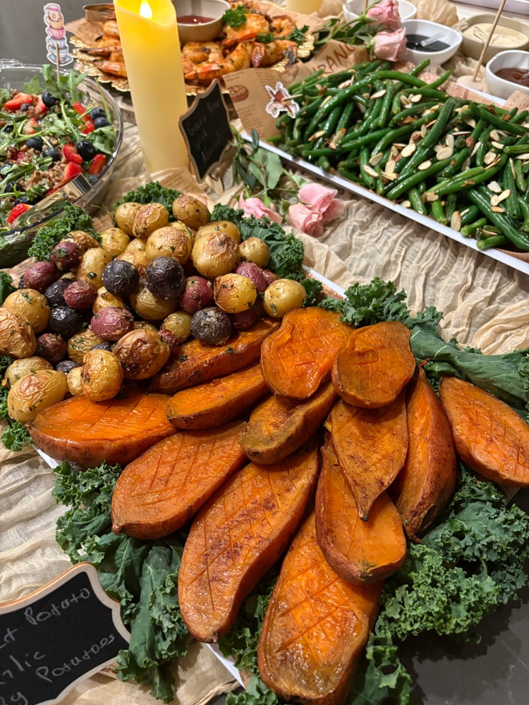 Roasted baby potatoes and maple cinnamon sweet potatoes on a buffet